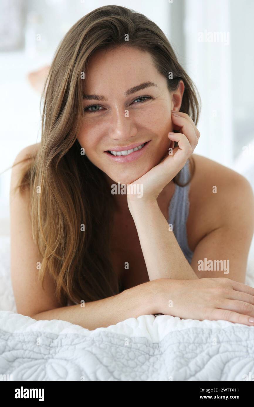 Woman smiling hand on chin hi-res stock photography and images - Alamy