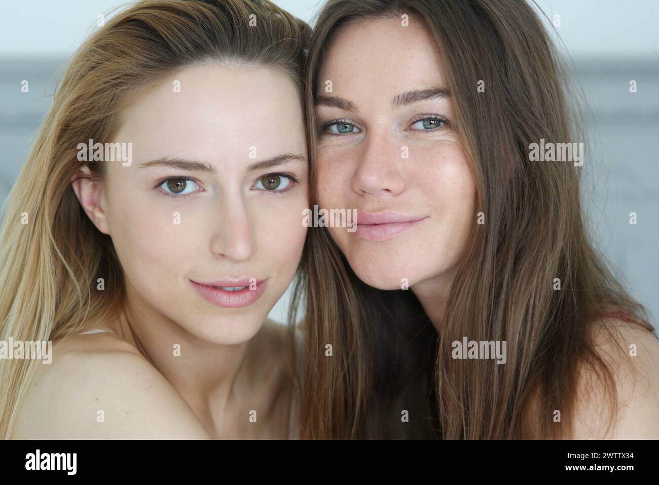 Two women posing closely with natural expressions. Stock Photo