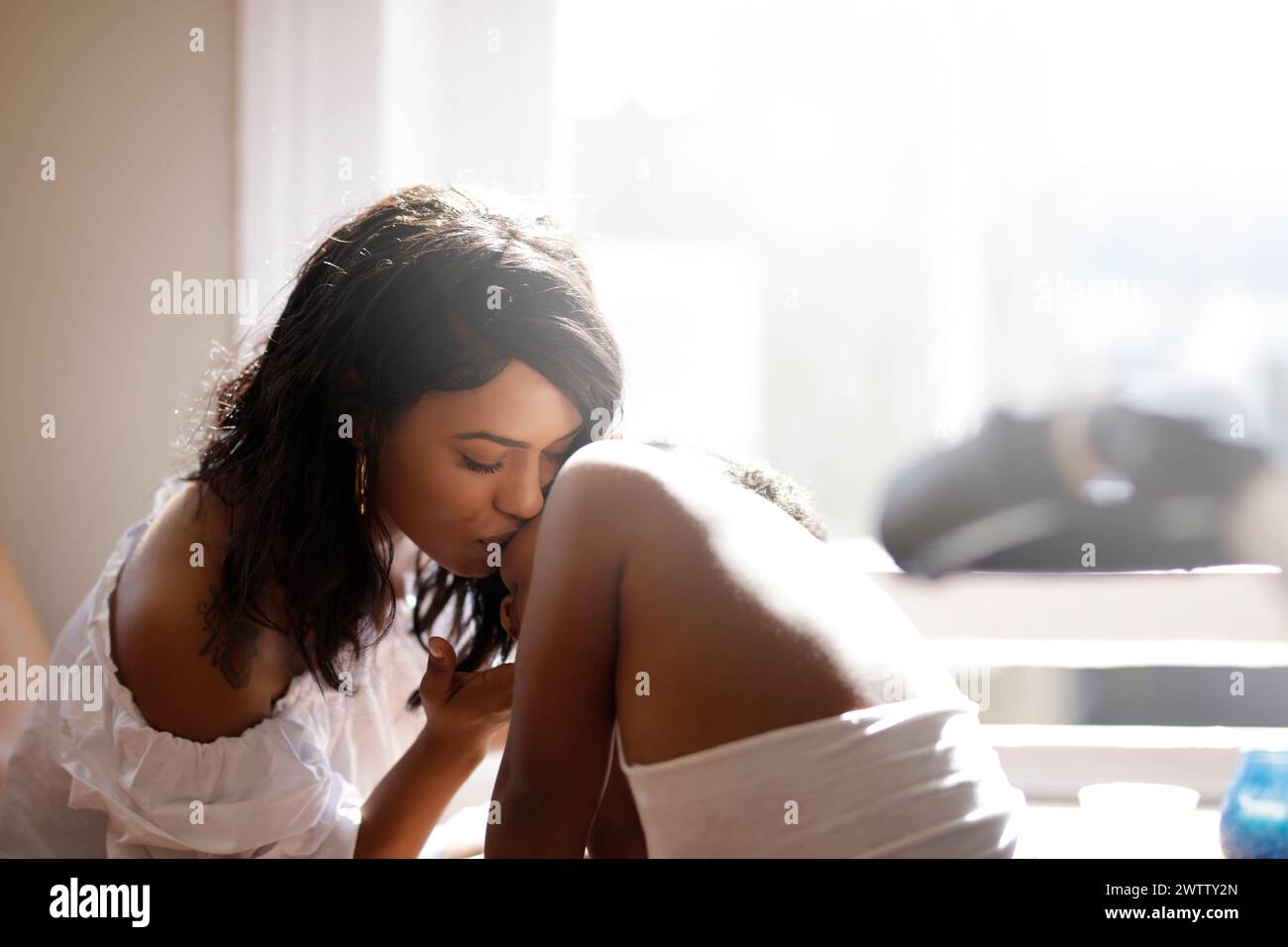 Woman sitting by the window in contemplation Stock Photo