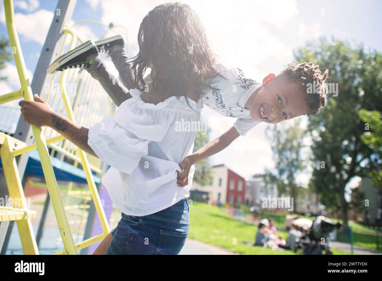 Child playing on a carousel in a park Stock Photo