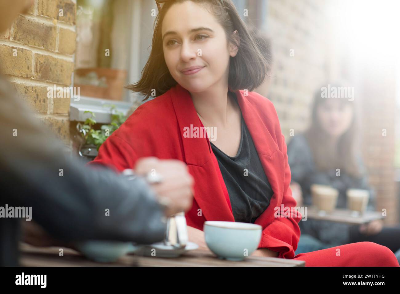 Woman in red blazer at a cafe Stock Photo
