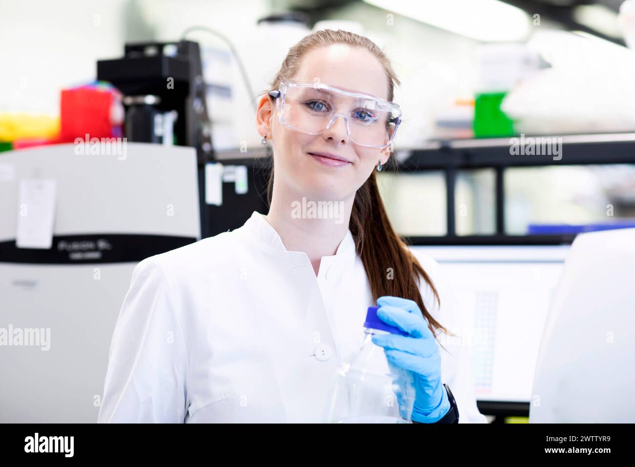 Confident scientist working in a lab with equipment Stock Photo