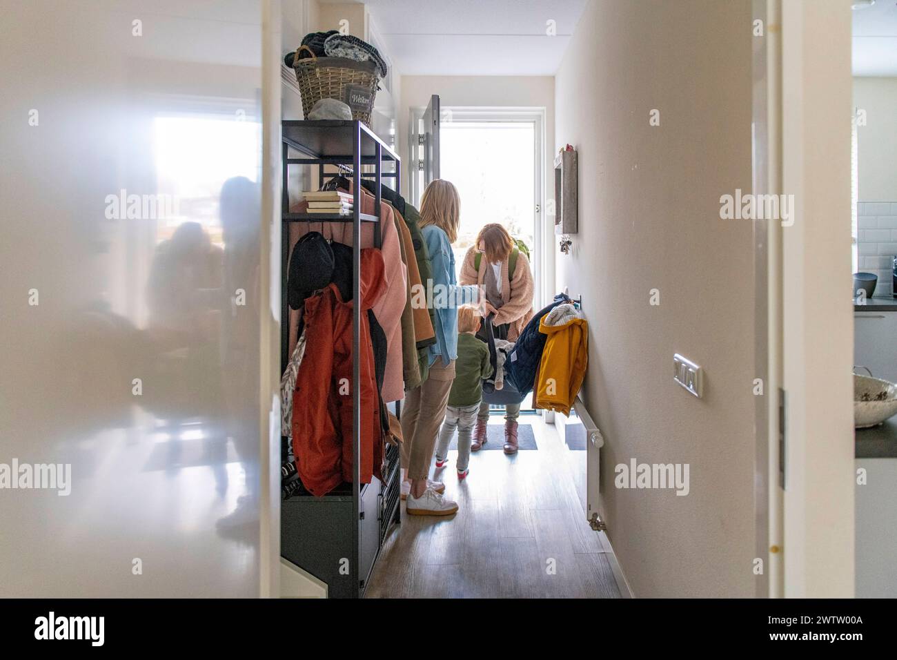 Family moment as they get ready to leave the house Stock Photo