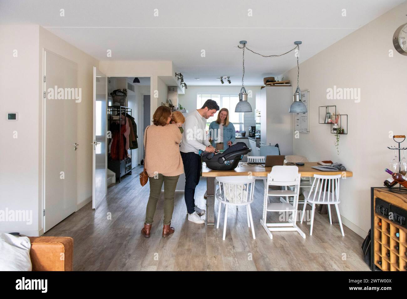 A cozy family moment in a modern home interior with natural light filtering in. Stock Photo