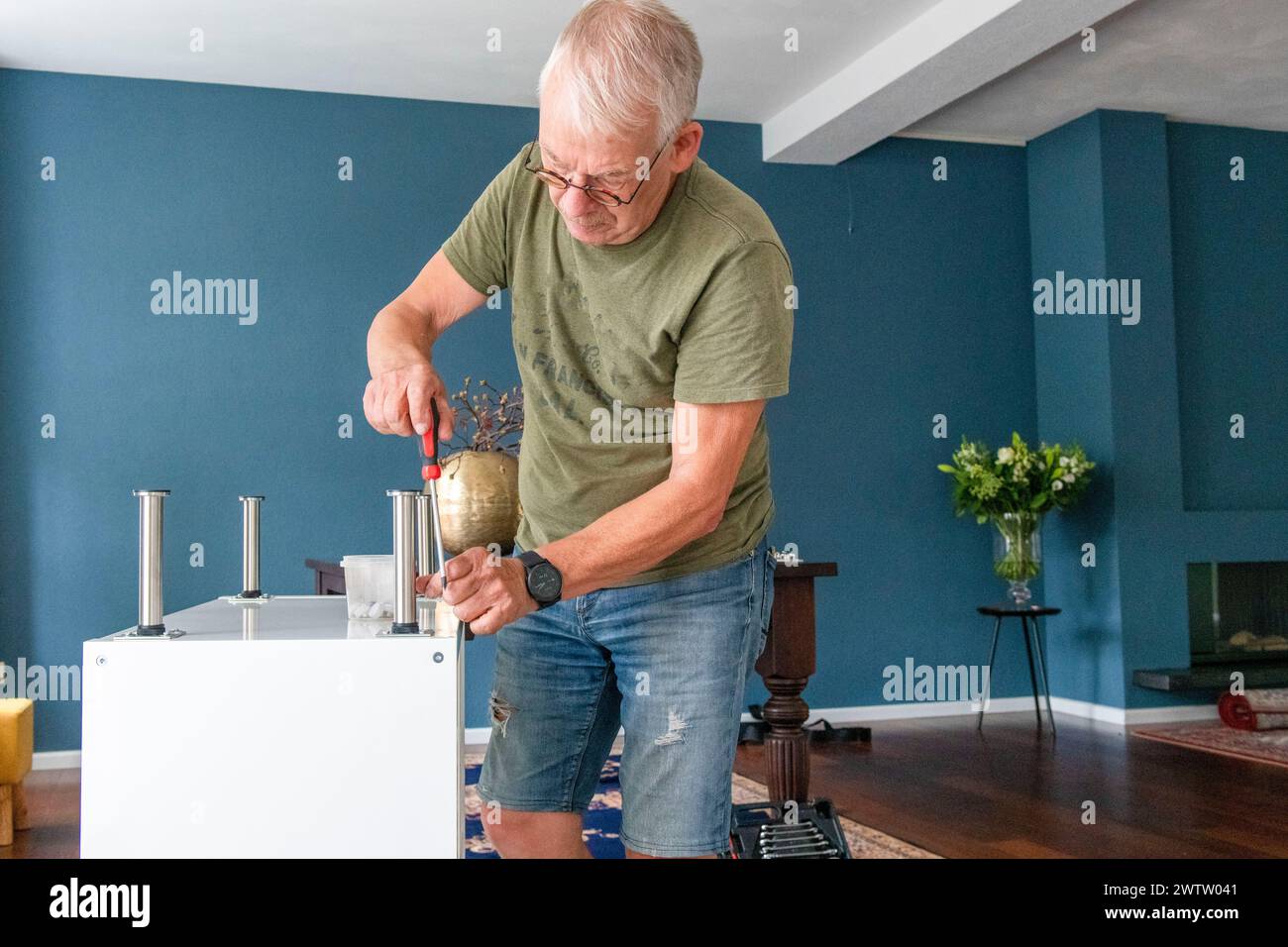 Senior man focused on a DIY project at home Stock Photo