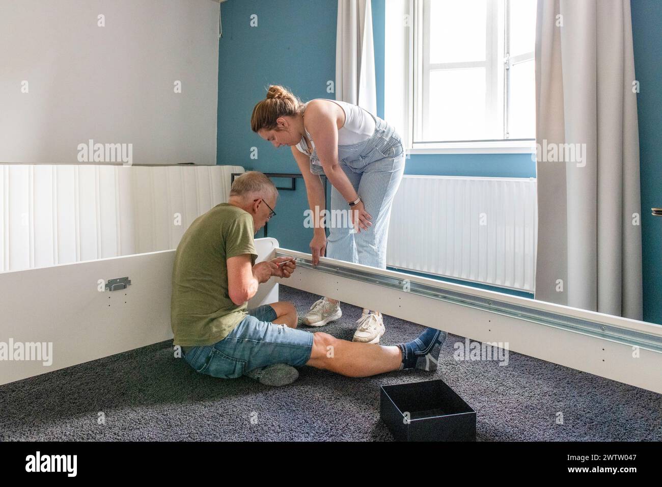 Two people working together on a home improvement project. Stock Photo