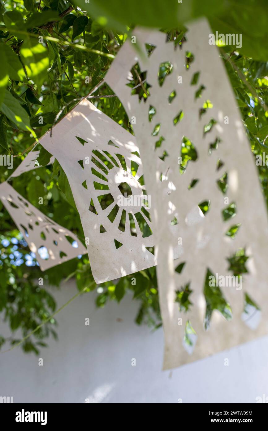 Paper cutouts hanging on a tree Stock Photo