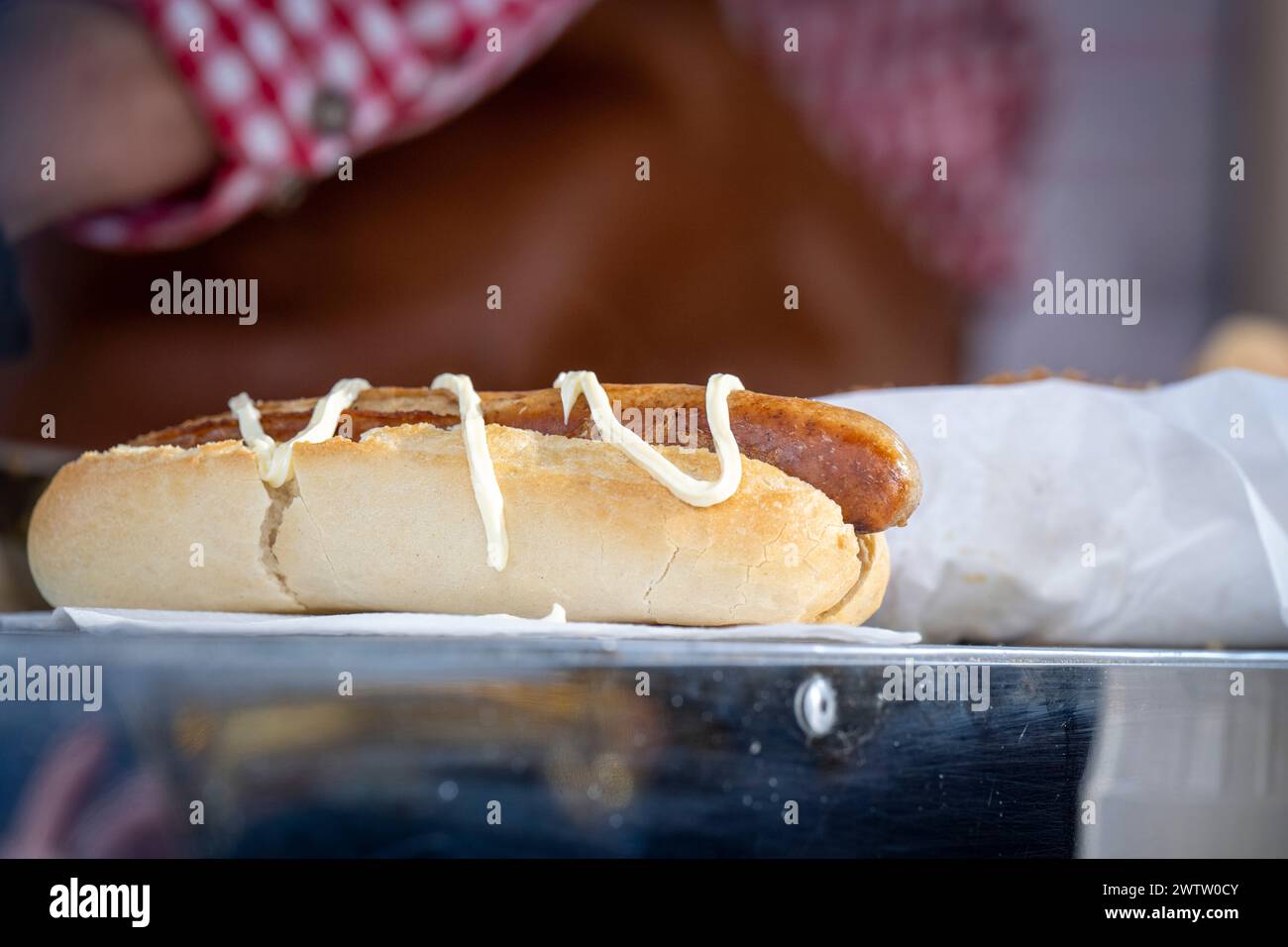 Hot dog with mustard on a counter Stock Photo