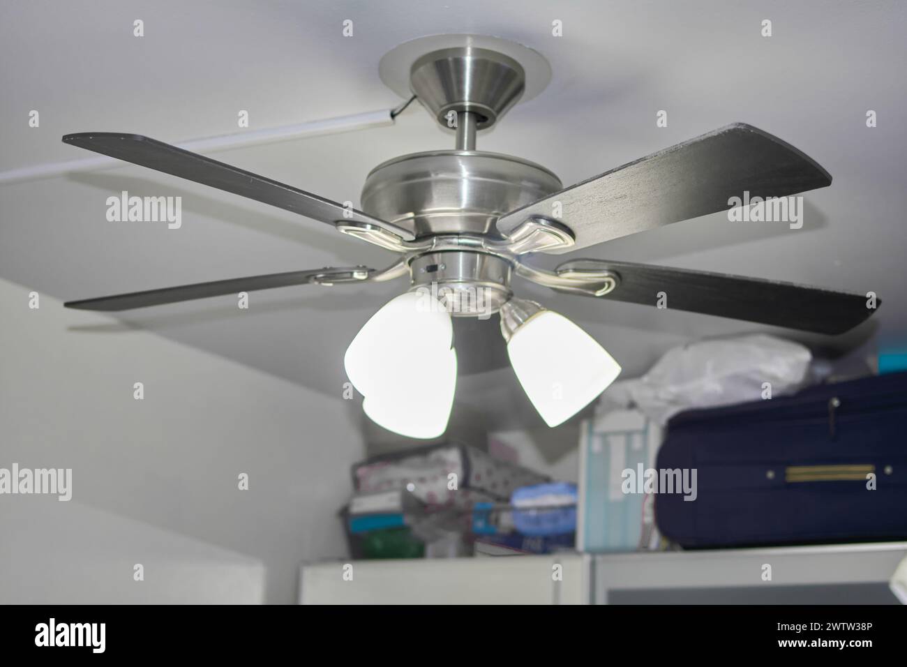 Elegant ceiling fan for a cool atmosphere and subtle lighting. Stock Photo