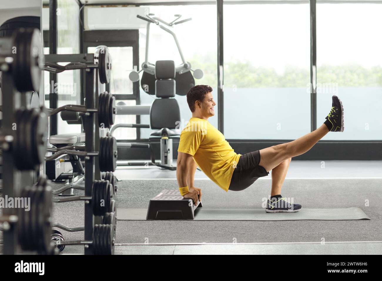 Man exercising with a step aerobic platform at a gym Stock Photo