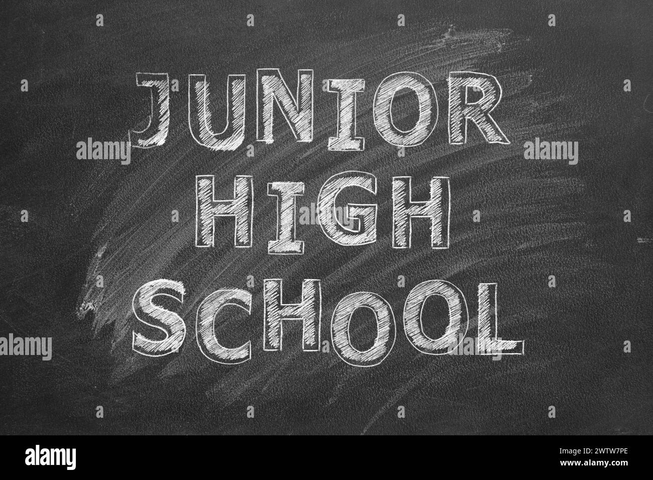 Lettering  Junior high school on black chalkboard. Stock Photo