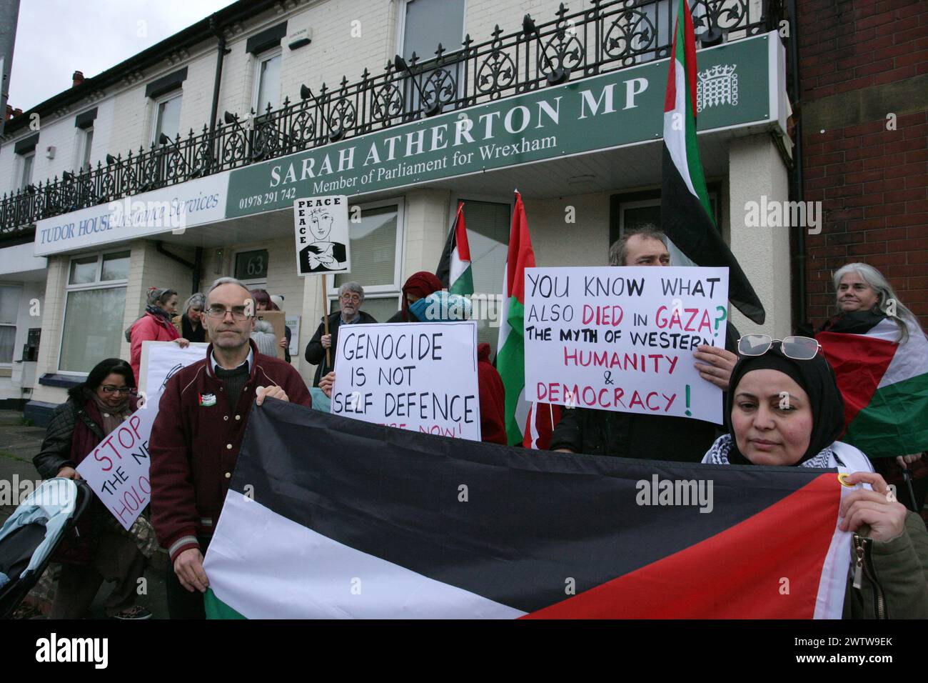 Wrexham, UK. 19th Mar, 2024. Pro-Palestine protesters holding placards and Palestinian flags picket outside Wrexham Conservative MP 'Sarah Atherton's' constituency office during a demonstration following the MP's repeated refusal to vote for an immediate ceasefire in Gaza. Demonstrators demand an immediate ceasefire and an end to the war crimes being perpertrated. Protestors state that Israel is committing nothing less than genocide in its wholesale slaughter of innocent civilians in Gaza. Credit: SOPA Images Limited/Alamy Live News Stock Photo