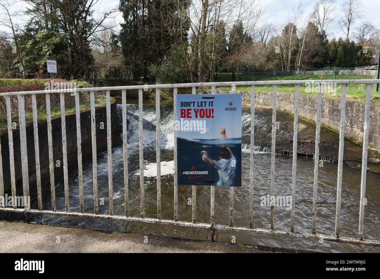 Warning sign Be water aware safety next to the river Sheaf in Millhouses Park, Sheffield, UK danger risk of drowning Stock Photo