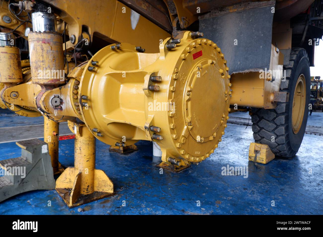 final drive and wheel hub of a giant mining dump truck being serviced at workshop Stock Photo