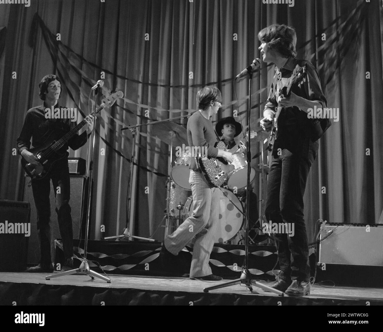Four piece, all male rock 'n' roll band performing on stage in the 60's. Stock Photo