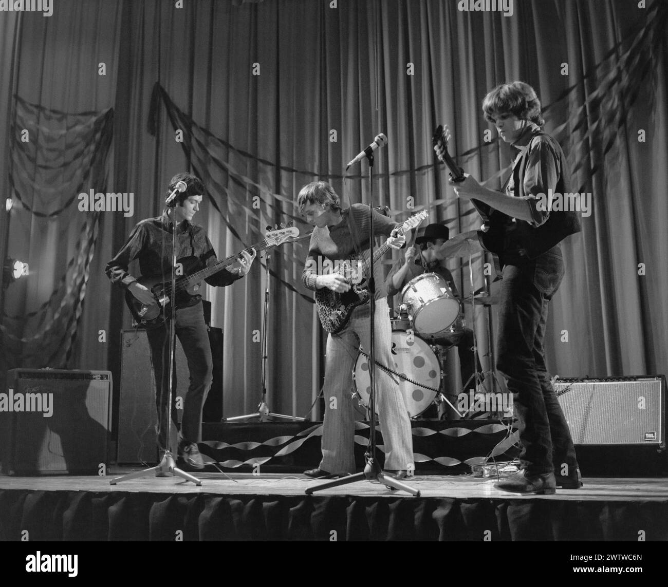 Four piece, all male rock 'n' roll band performing on stage in the 60's Stock Photo