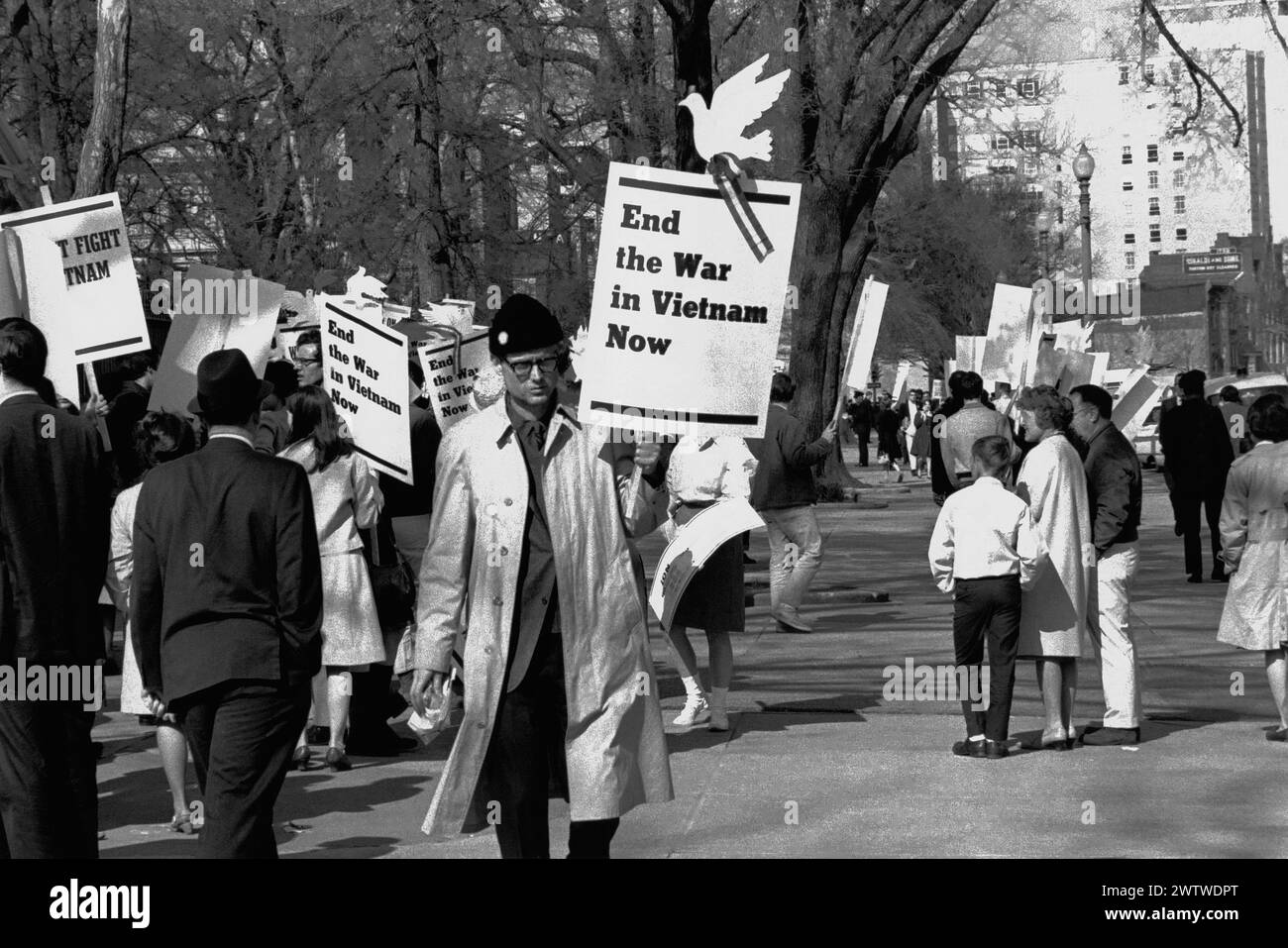 Men, women and children on the sidewalk carrying posters to end the war in Vietnam in Washington, DC Stock Photo