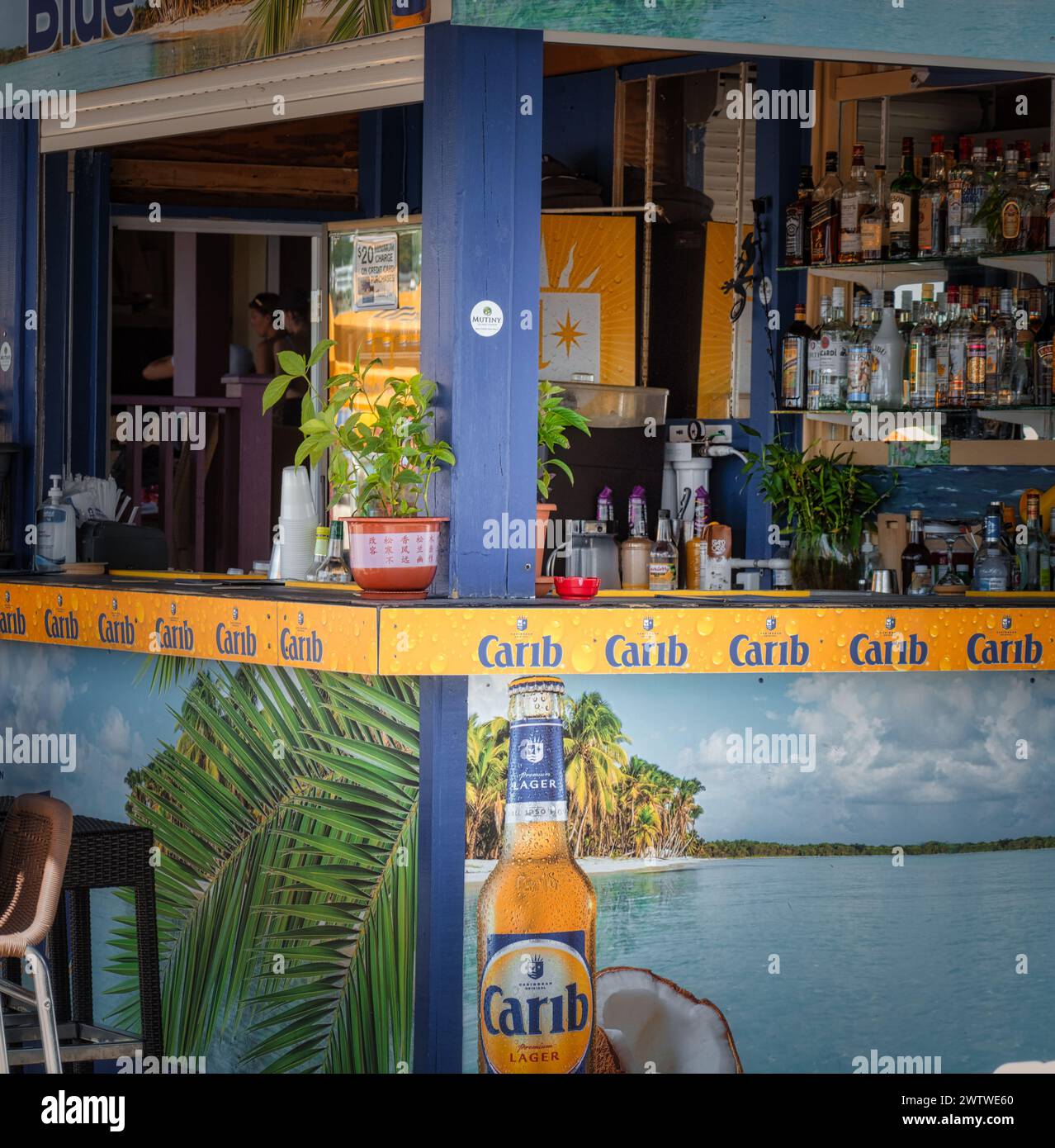 A lively tropical bar entrance decorated with Carib branding, inviting guests to a carefree vacation vibe Stock Photo