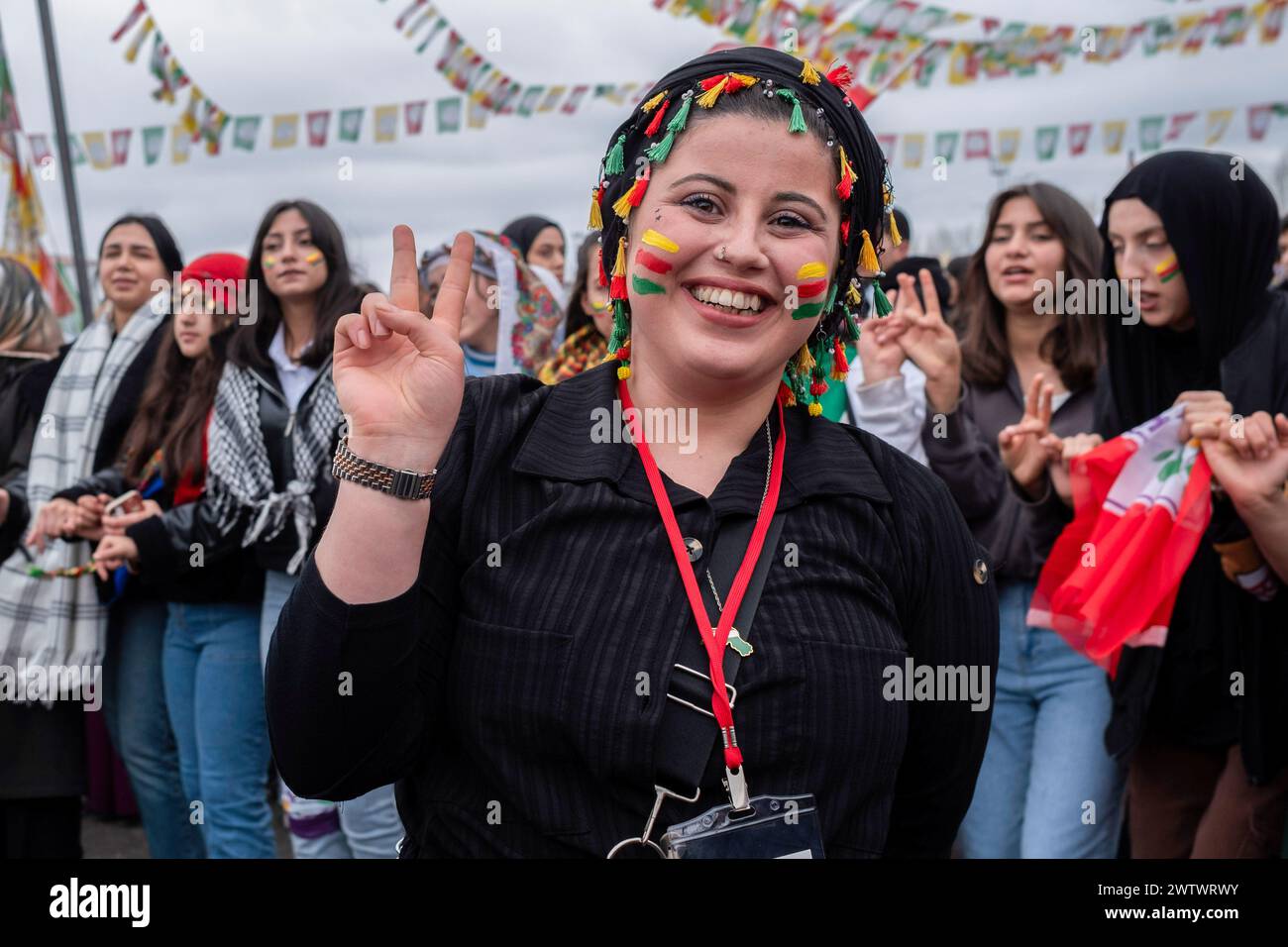 Batman, Turkey. 19th Mar, 2024. A woman makes a victory sign during the celebration. Tens of thousands of people gathered in Batman to celebrate the arrival of the new year and spring with great enthusiasm and their colorful costumes. Credit: SOPA Images Limited/Alamy Live News Stock Photo