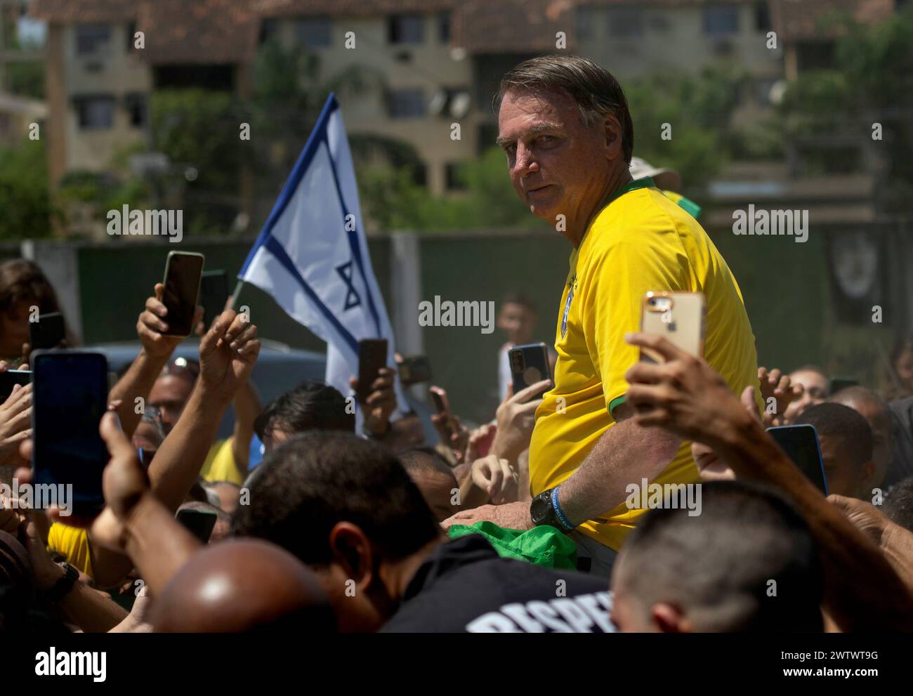 Brazil's former President Jair Bolsonaro is surrounded by supporters ...