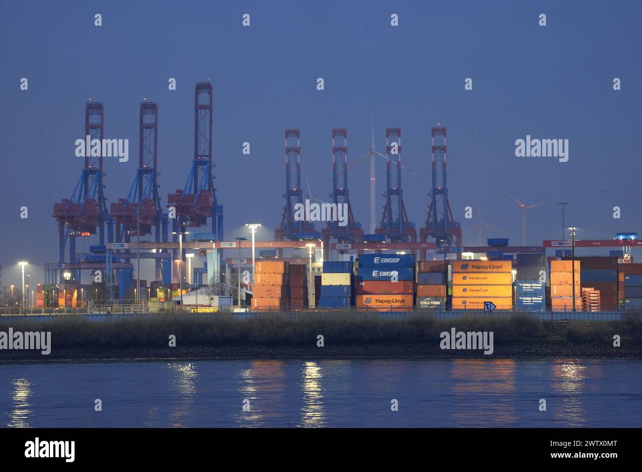 20 March 2024, Hamburg: Container gantry cranes and containers can be ...