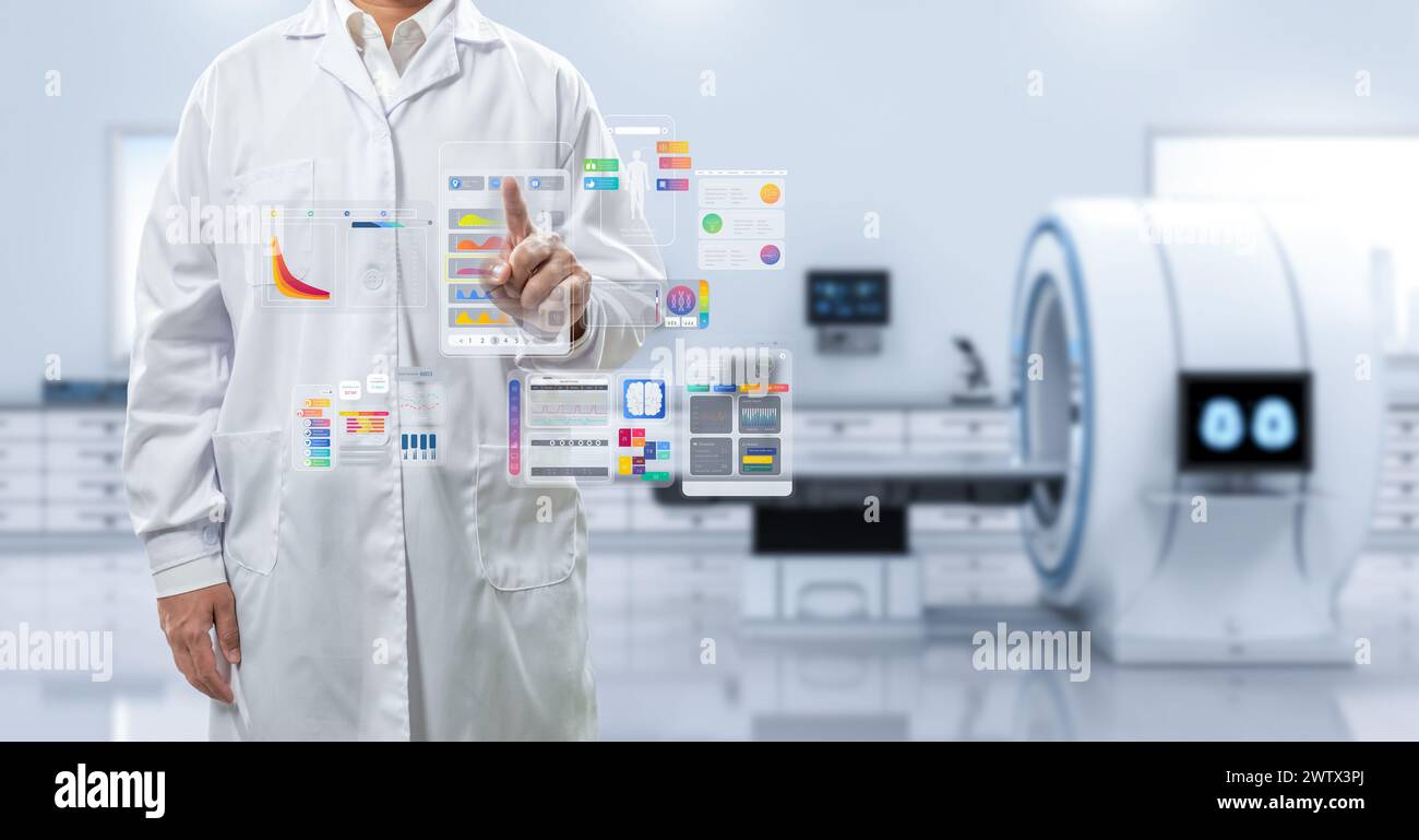 Doctor with graphic interface display in hospital room with mri scanner machine Stock Photo