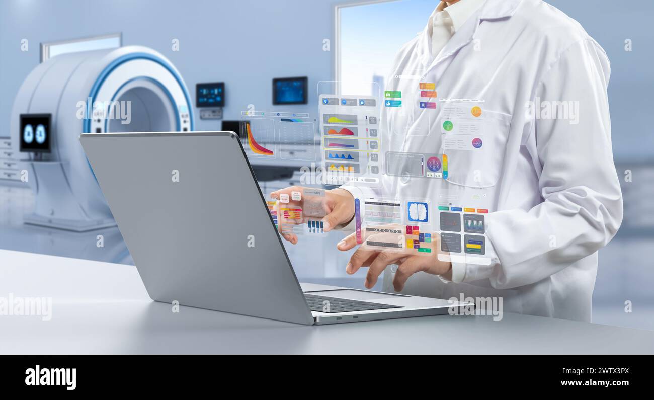 Doctor with graphic interface display in hospital room with mri scanner machine Stock Photo