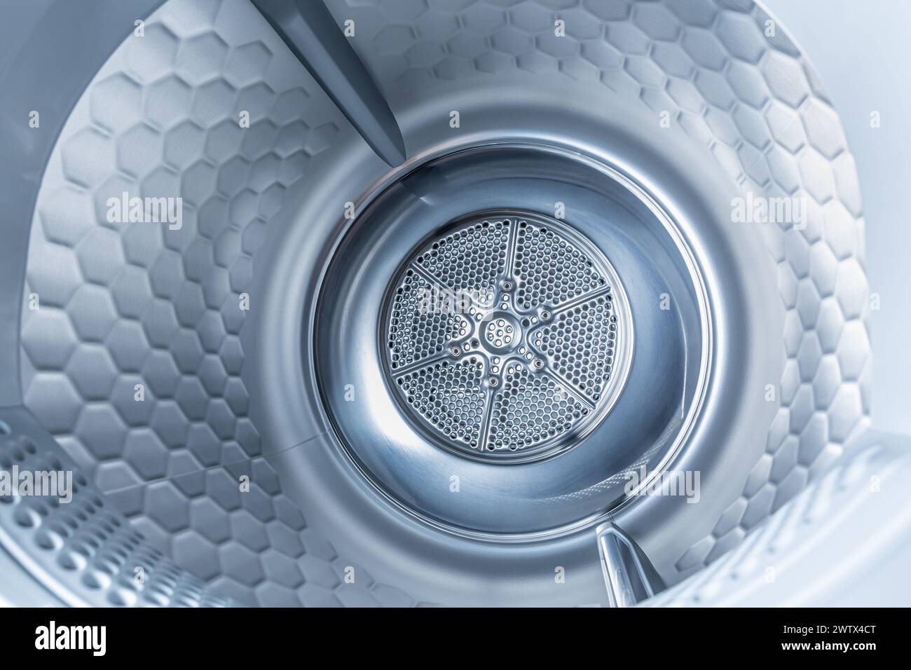 Inside of tumble dryer with clean laundry - new generation of heat pump dryer, household concept Stock Photo