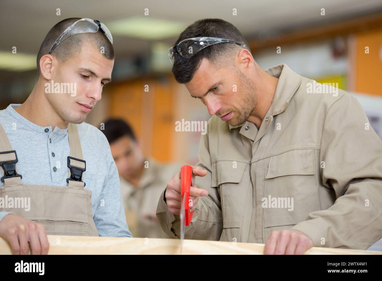 Male apprentice carpenter learning hi-res stock photography and images ...