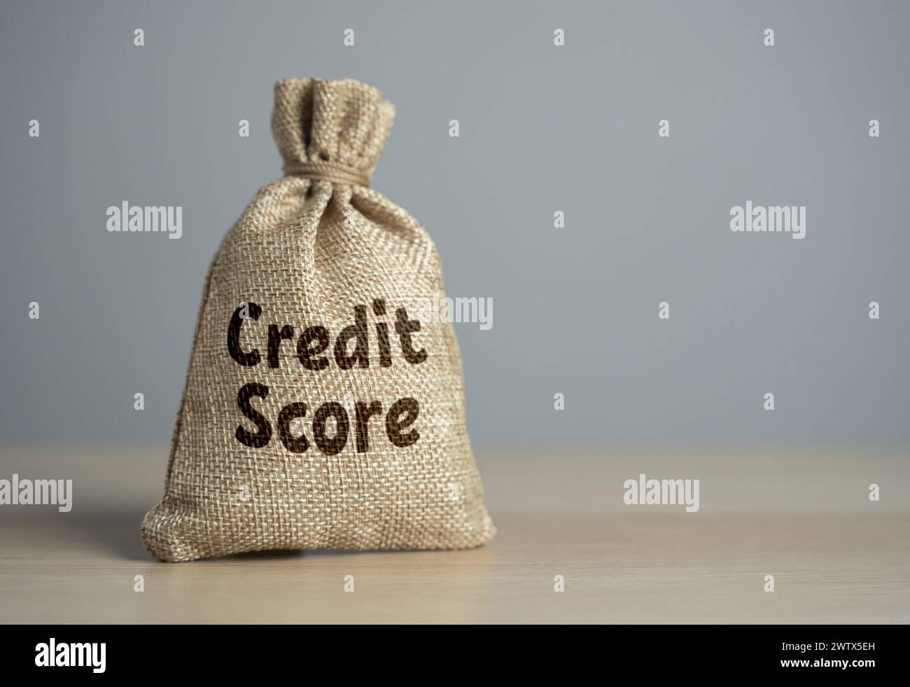 Bag with credit score. High costs, expensive loan servicing, low credit rating. Seeking advice, budgeting consciously, and exploring debt management o Stock Photo