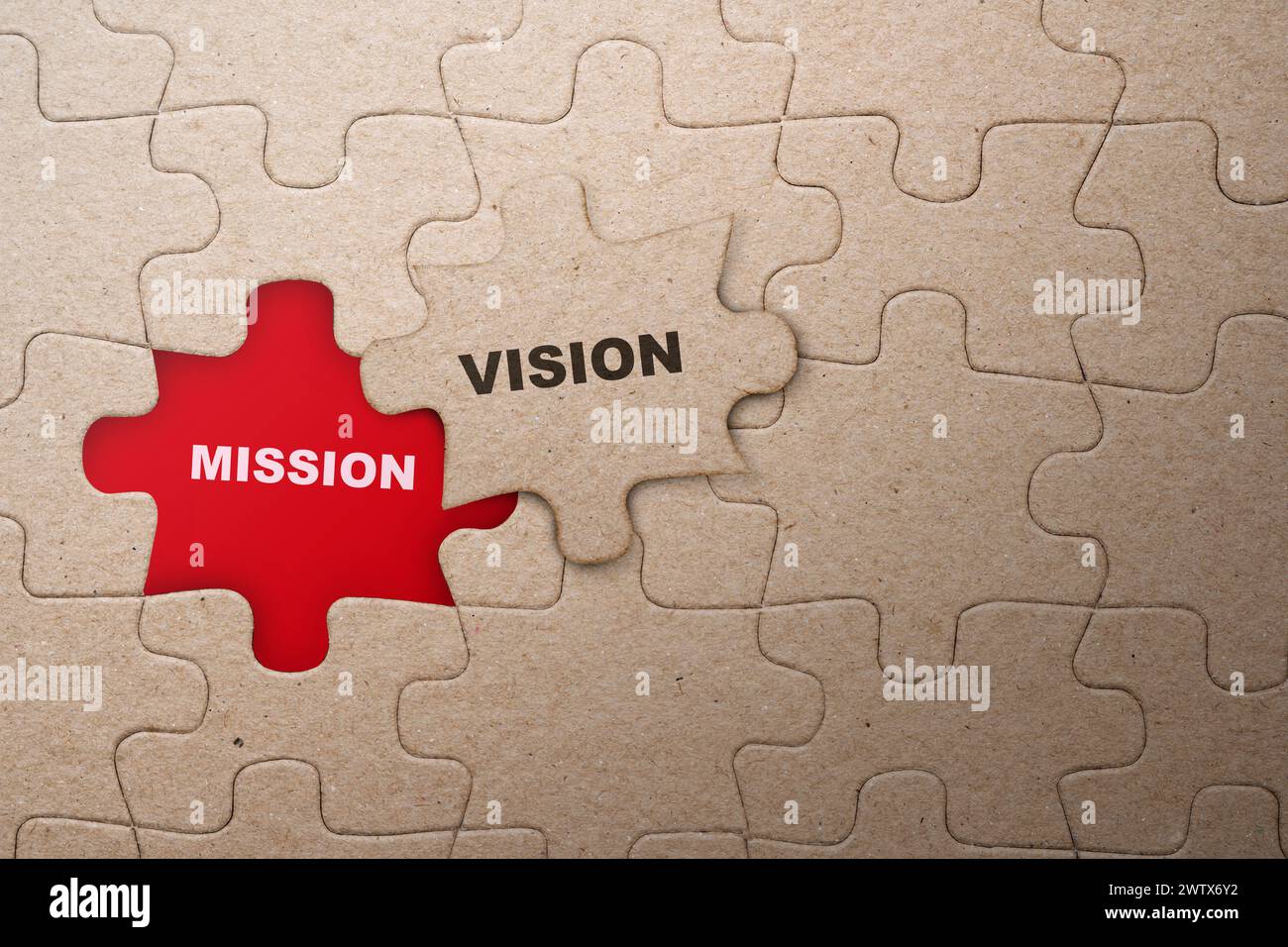 Piece of missing jigsaw puzzle with mission and vision text on a red ...