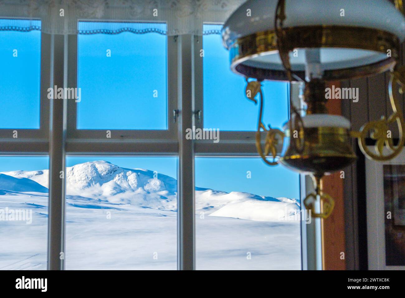 Winter view through the window at Bygdin Fjellhotell / mountain hotel in the Jotunheim region of Norway Stock Photo