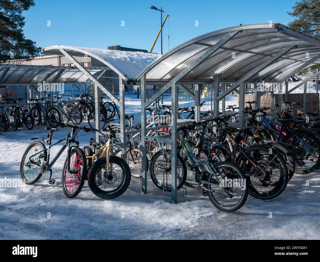 A bicycle parking spot at a school yard in wintertime, Kempele Finland Stock Photo