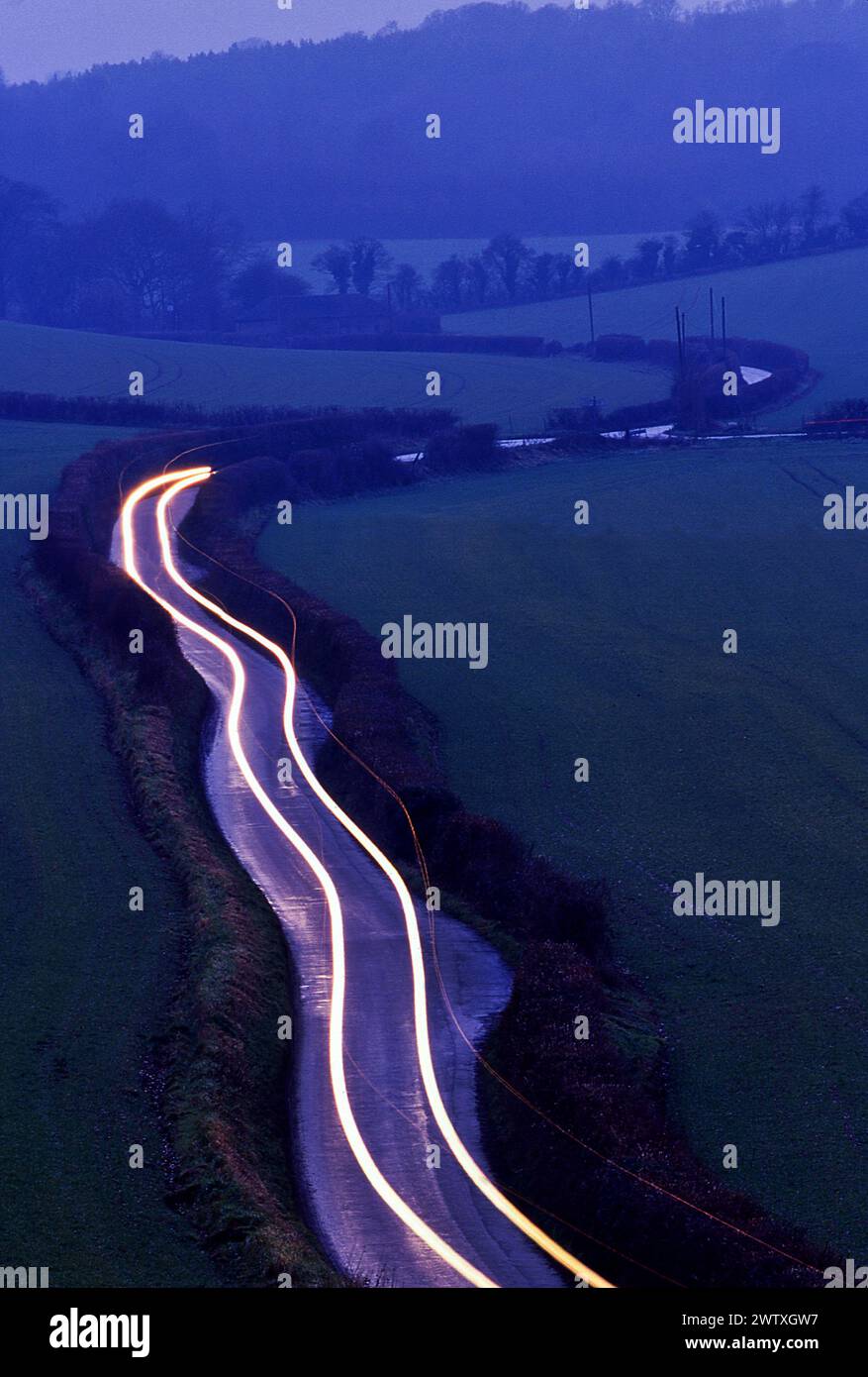 Rural road at night with traffic Stock Photo