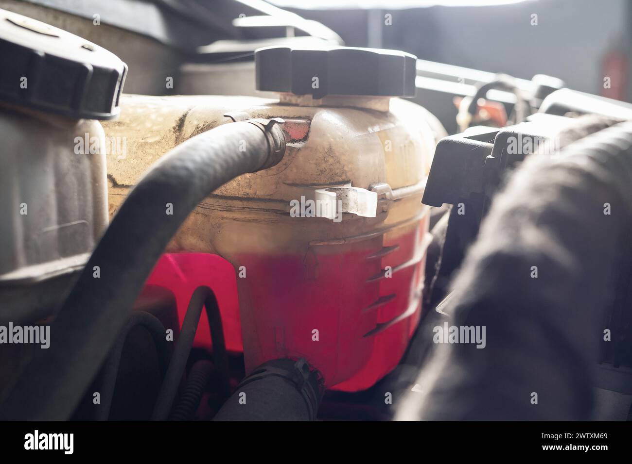 Dirty tank of a car filled with antifreeze, engine coolant Stock Photo