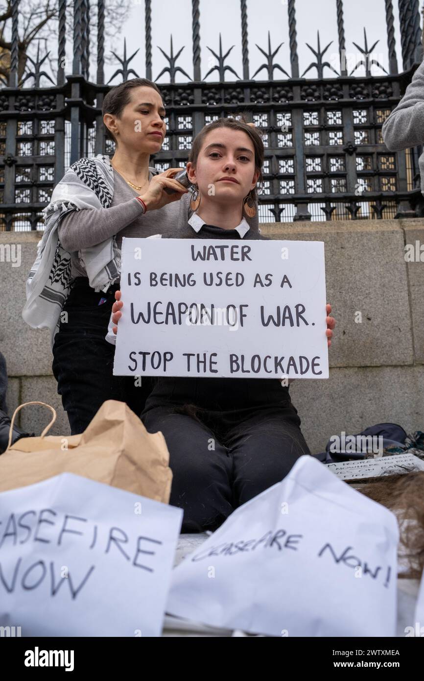 London, UK, 19th, March 2024. Activist shave their heads outside the Houses Of Parliament in solidarity with women of Gazza.  Credit: James Willoughby Stock Photo