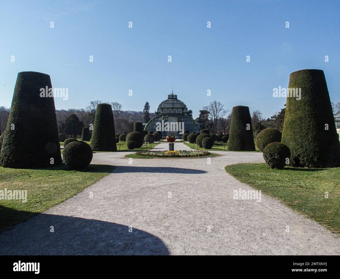 Vienna, Austria, Austria. 20th Mar, 2024. Topiary bushes line a path towards the greenhouse pavilion at the Schonbrunn gardens. The palace, former summer residence of the Habsburg family with vast garden, is now a UNESCO site.Schonbrunn also means Beautiful Spring in German. (Credit Image: © Bianca Otero/ZUMA Press Wire) EDITORIAL USAGE ONLY! Not for Commercial USAGE! Stock Photo