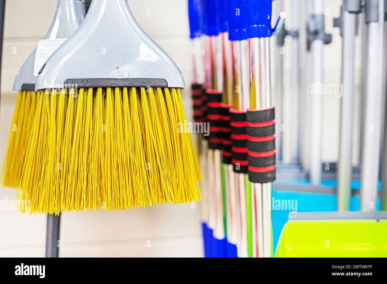 yellow brush for cleaning premises in a supermarket Stock Photo