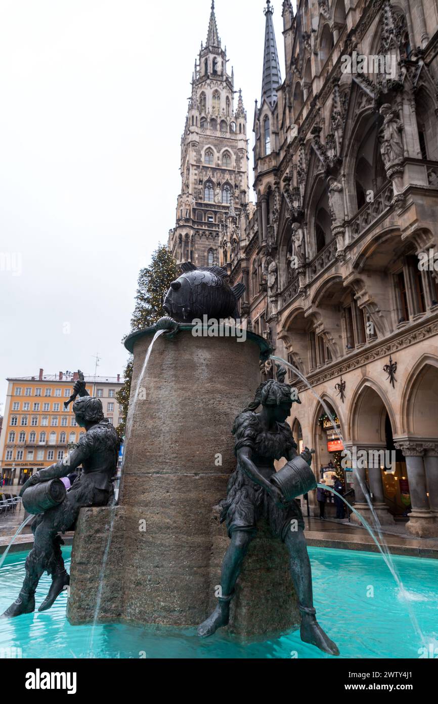 Munich, Germany - December 26, 2021: Fischbrunnen, the Fish Fountain and the New Town Hall in Marienplatz, the town square in historic center, Germany Stock Photo