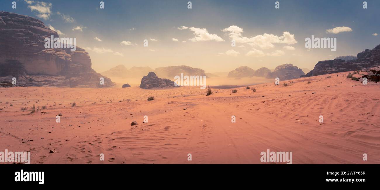 Desert scene at Wadi Rum, Jordan, light sand storm in the distance, creating mars-like alien planet atmosphere Stock Photo