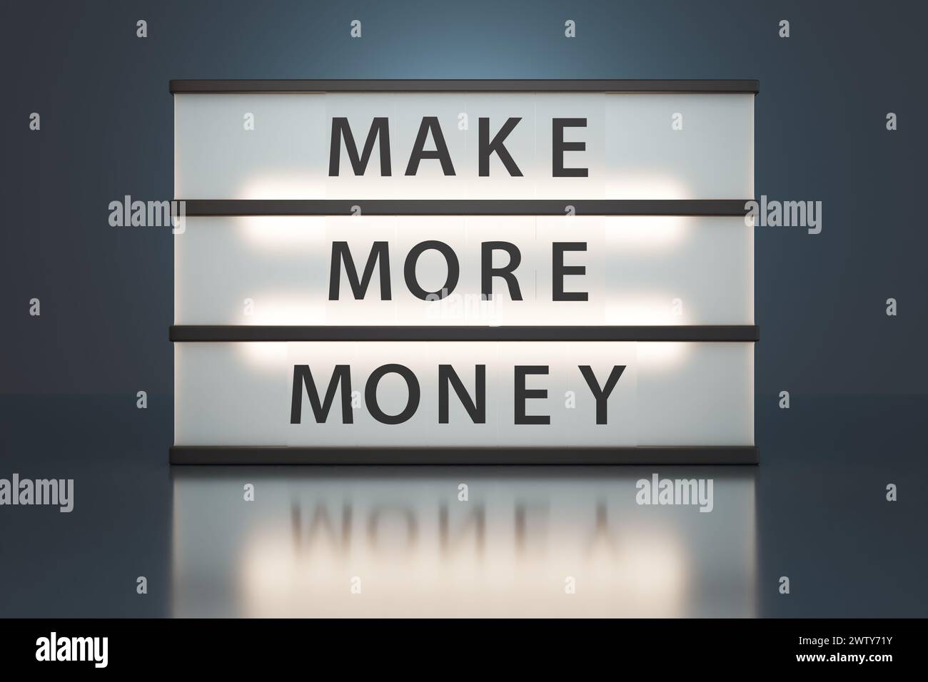Miniature classic cinema light box showing the words MAKE MORE MONEY in dark background. Concept of ambition of earning money and income streams Stock Photo