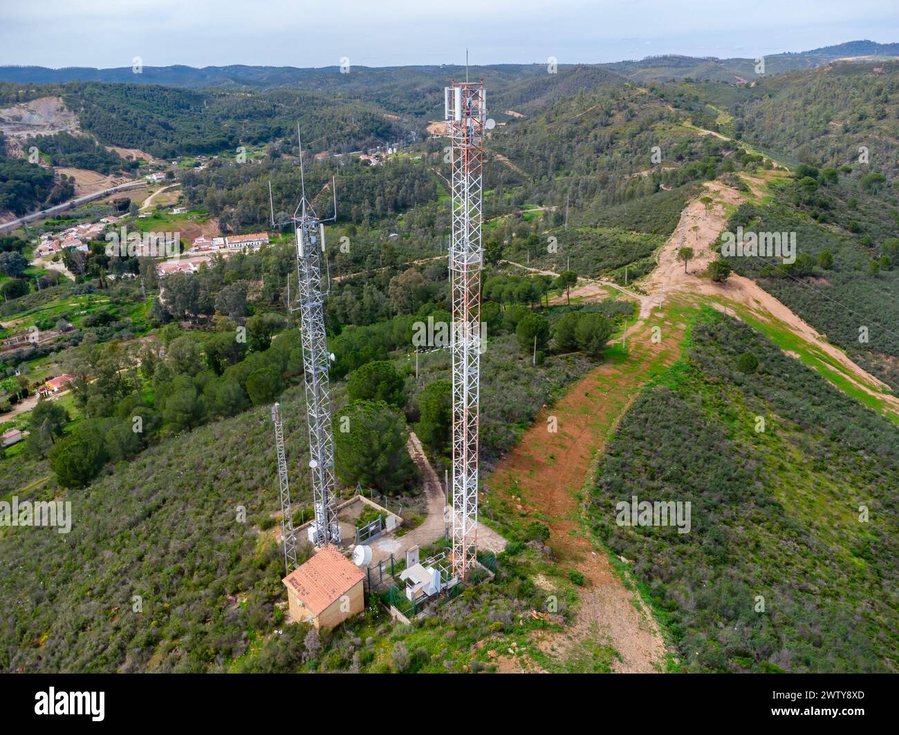 Aerial drone view of GSM, 4G, 5G and radio telecommunication towers on the top of a mountain. Cell phone tower and transceiver station. Antenna transm Stock Photo