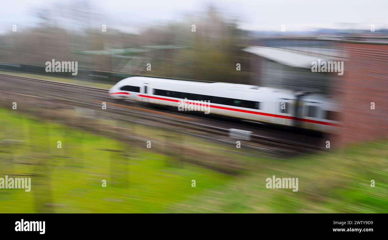 Eschede, Germany. 20th Mar, 2024. An ICE train travels on the railroad line between Hanover and Hamburg (picture with long shutter speed). Both sides in the wage dispute at Deutsche Bahn have resumed negotiations. According to a statement from Deutsche Bahn, the company and the train drivers' union GDL are confident of reaching an agreement this week. Credit: Julian Stratenschulte/dpa/Alamy Live News Stock Photo