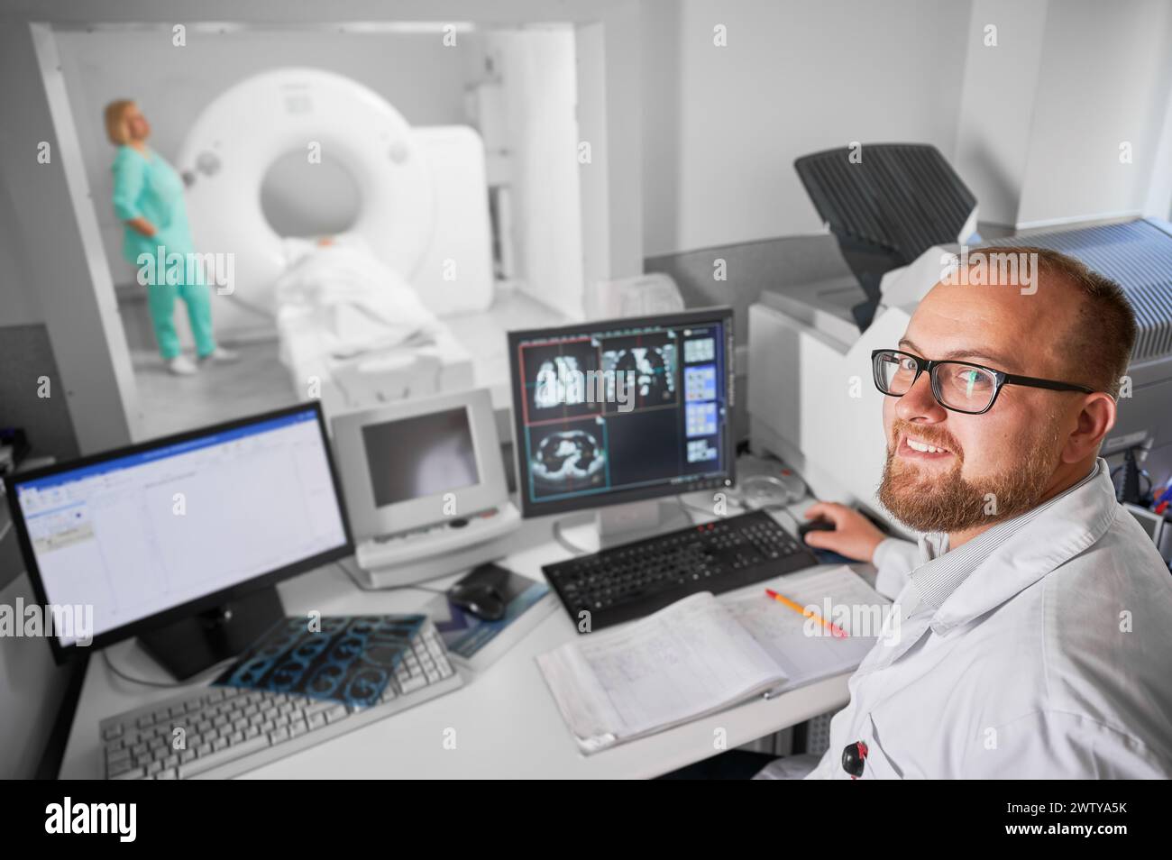 Medical computed tomography or MRI scanner. Doctor smiling to camera ...