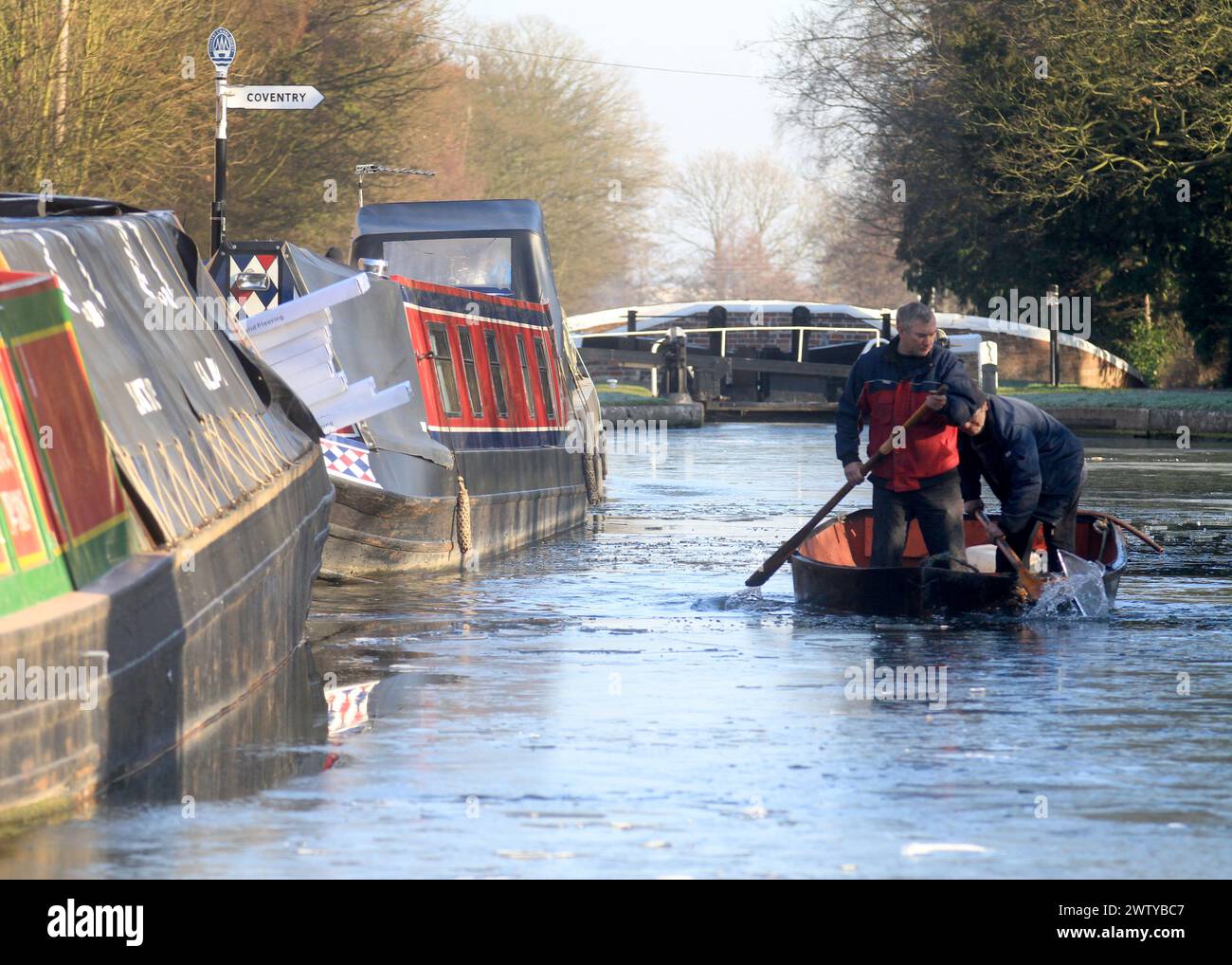 03/02/12.  ..Marine Engineers, Andy Poacher and Graham Donohue, use oars and a rowing boat to break up ice at Fradley Junction, the meeting point of t Stock Photo