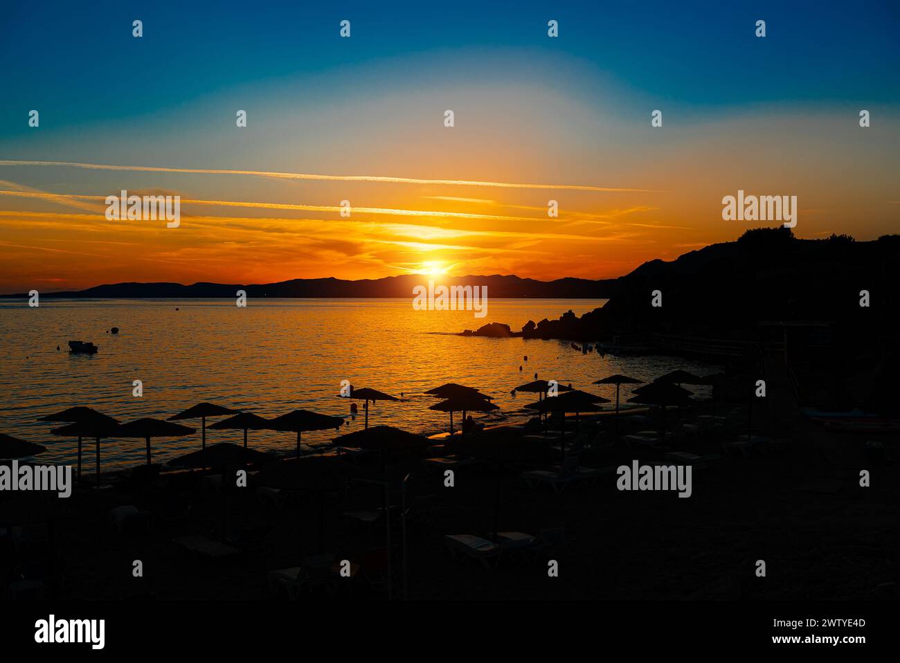 Beautiful sunset on Pefkos beach on the island of Rhodes in Greece. Stock Photo