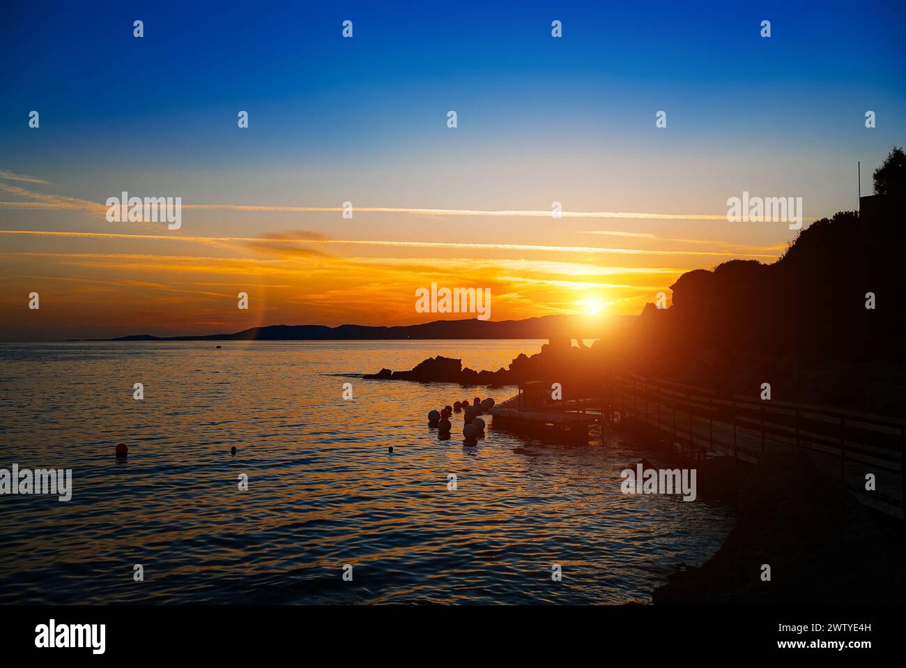 Beautiful sunset on Pefkos beach on the island of Rhodes in Greece. Stock Photo