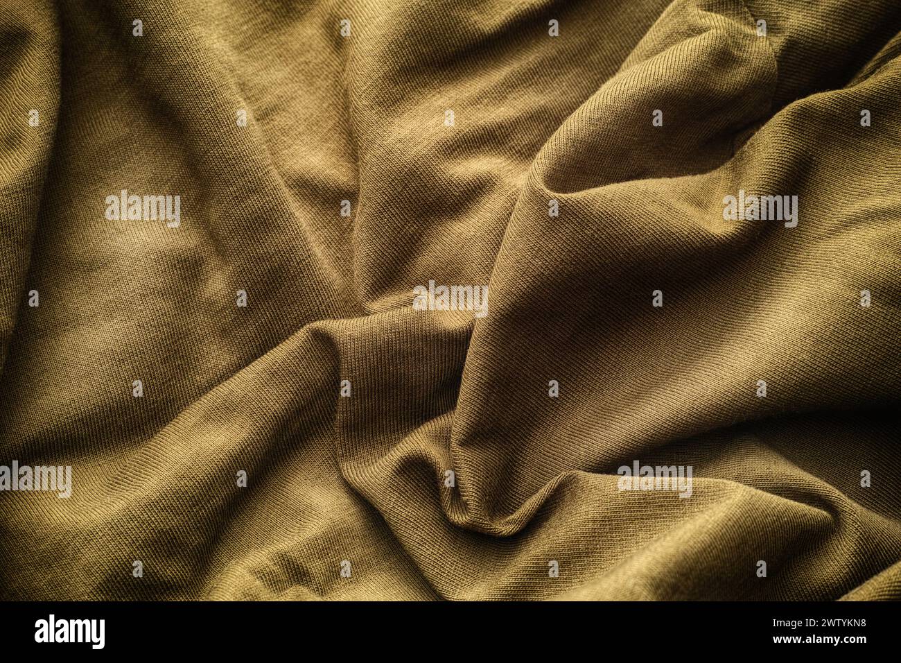 A crumpled beige fabric texture background. Close up. Stock Photo