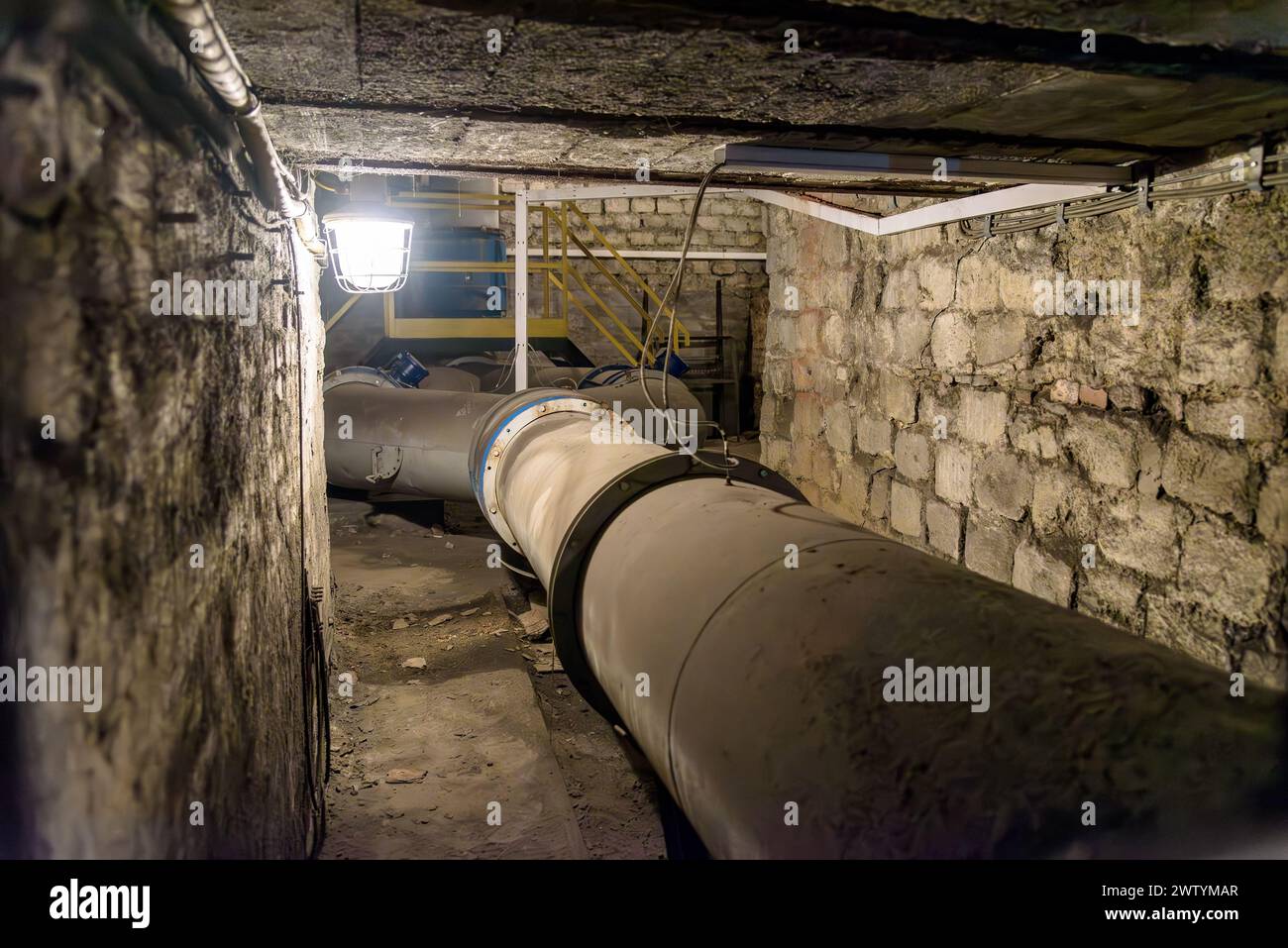 Big pipes of coal mine ventilation system in underground tunnel Stock Photo