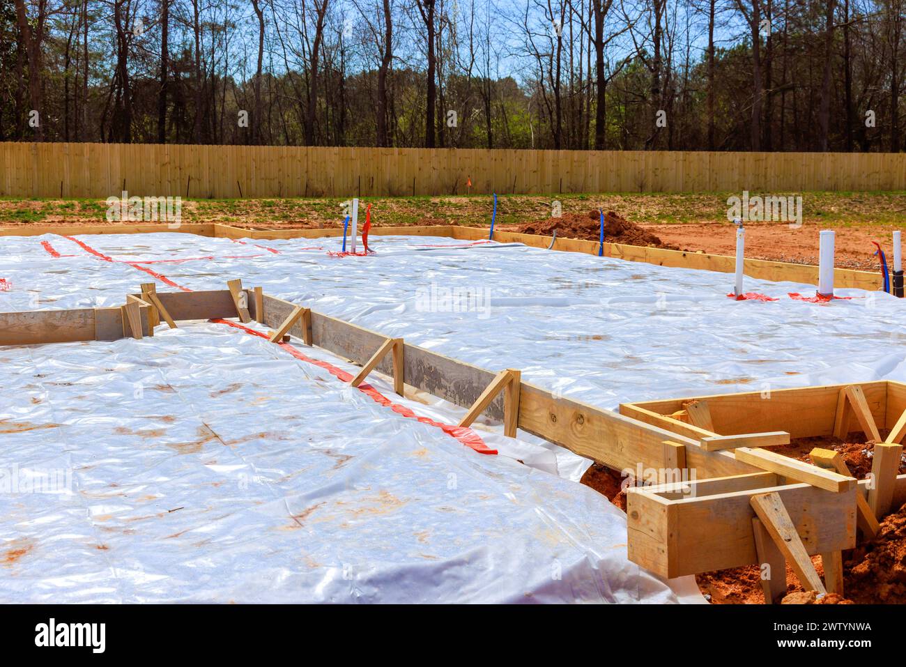 Immediately prior to pouring of foundation, ground is covered with first layer insulation waterproofing membrane Stock Photo